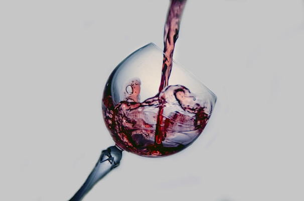 Close-up of a rich red wine being poured into a crystal glass at Angolo Divino