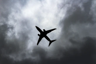 passenger plane under white clouds