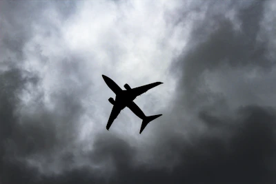 passenger plane under white clouds