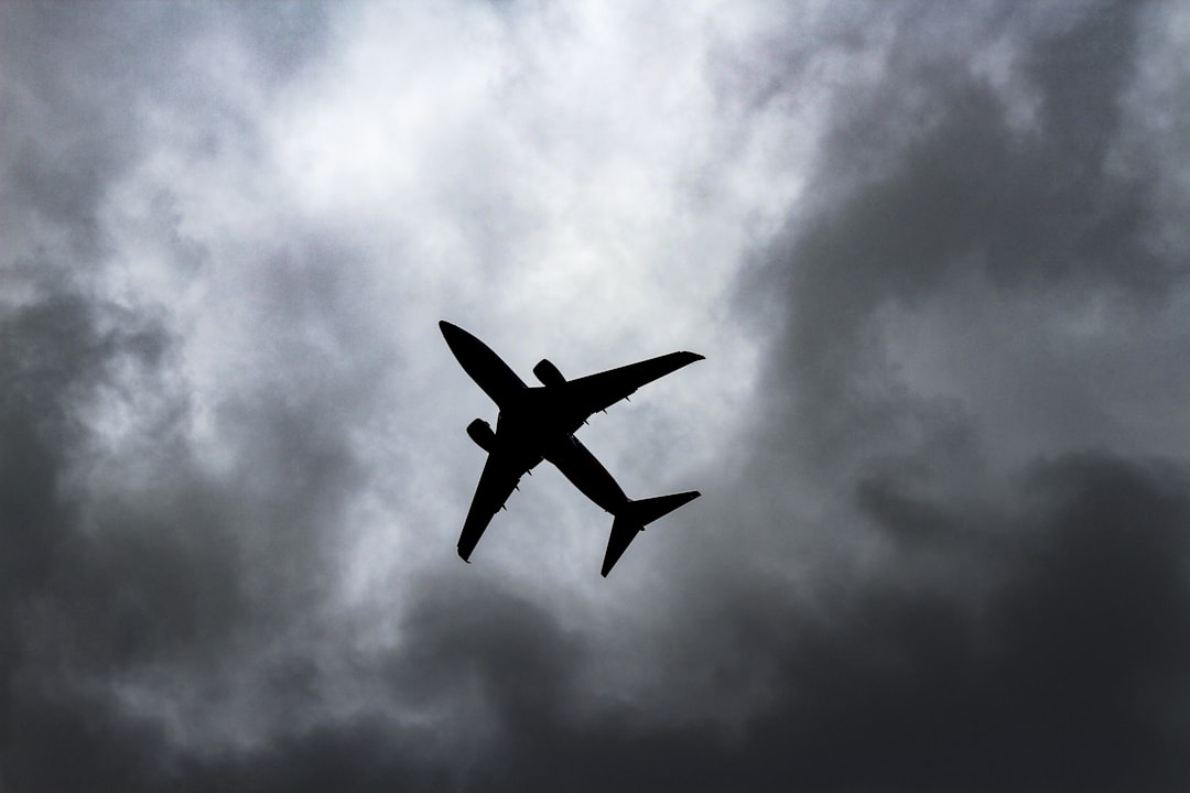 passenger plane under white clouds,