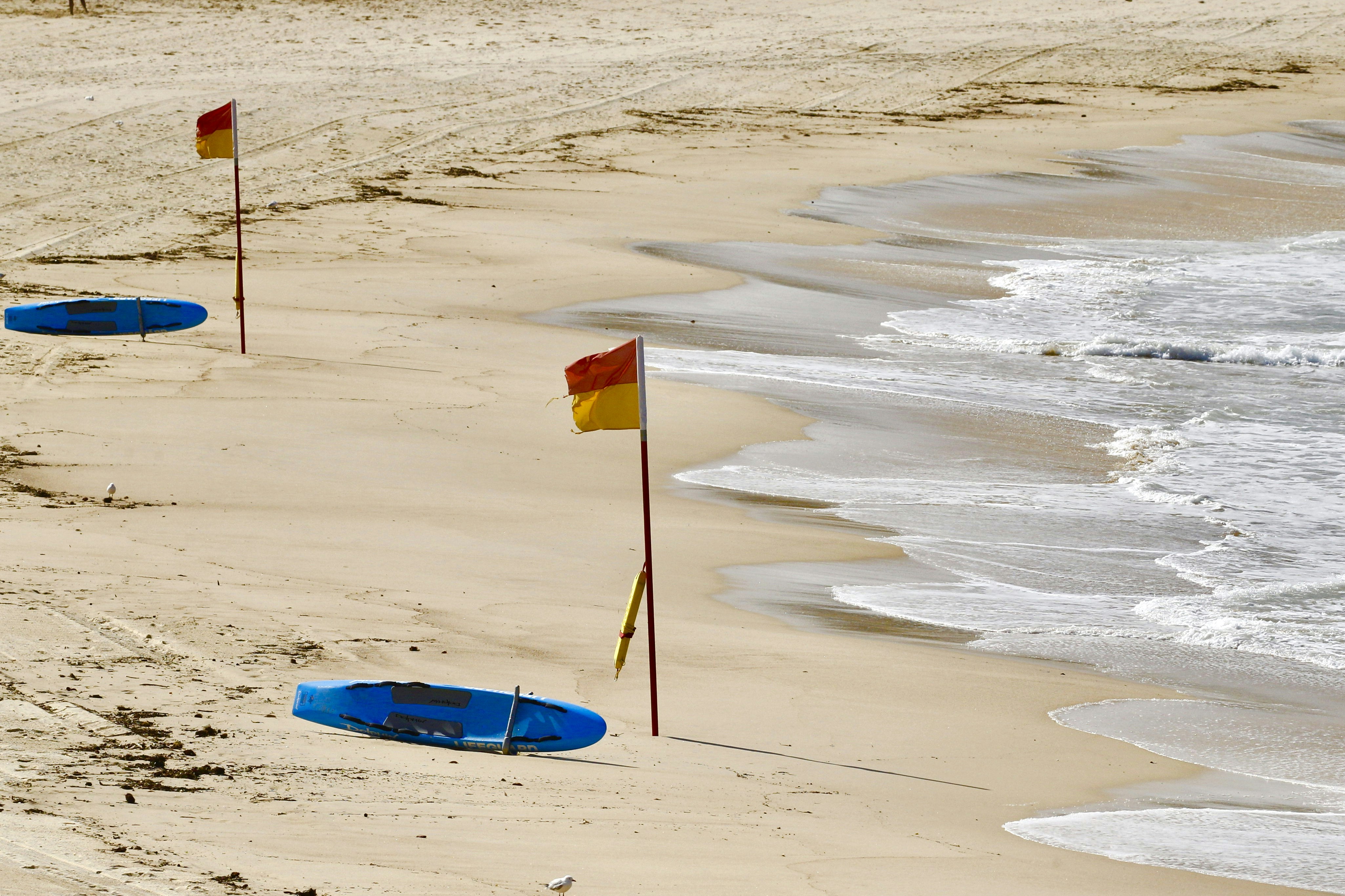 blue surfboard on white sand