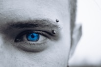 selective photo of man's blue eye