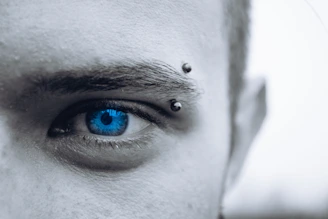 selective photo of man's blue eye