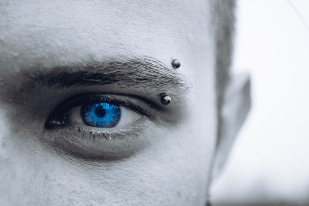 selective photo of man's blue eye