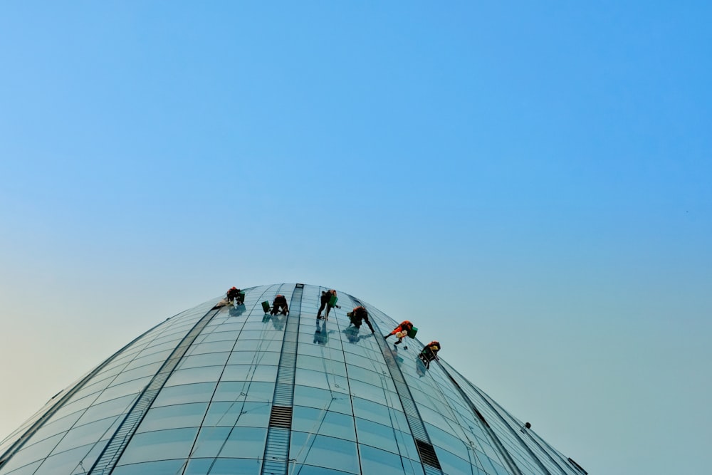 people hanging on building