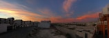 A panoramic view of a modern residential complex in Al Ain at sunset.