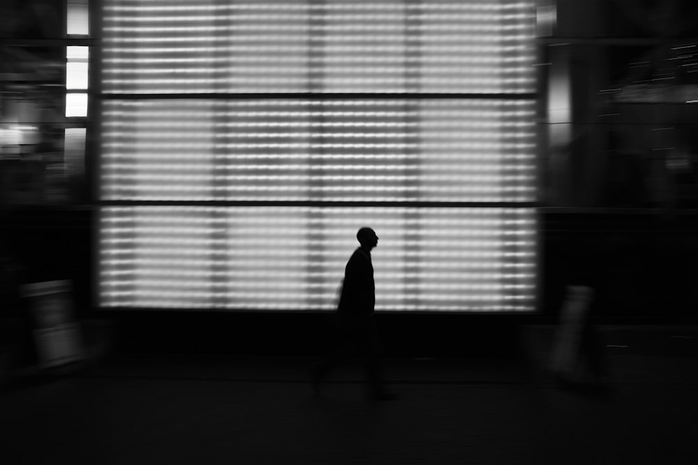 silhouette of person near white LED light