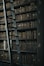 library shelf near black wooden ladder