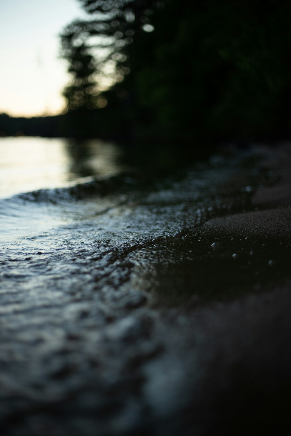 selective focus photography of water crashing on land at daytime