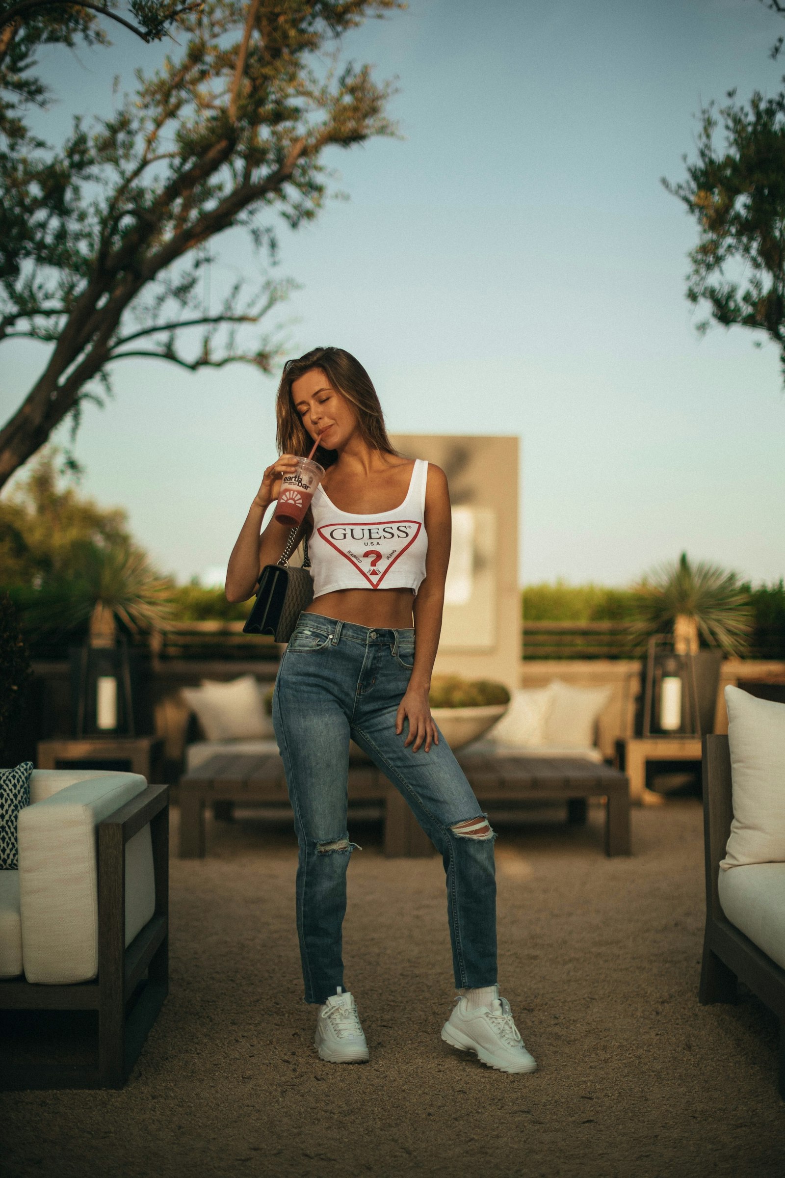 Canon EOS-1D X Mark II + Canon EF 50mm F1.2L USM sample photo. Woman holding plastic cup photography