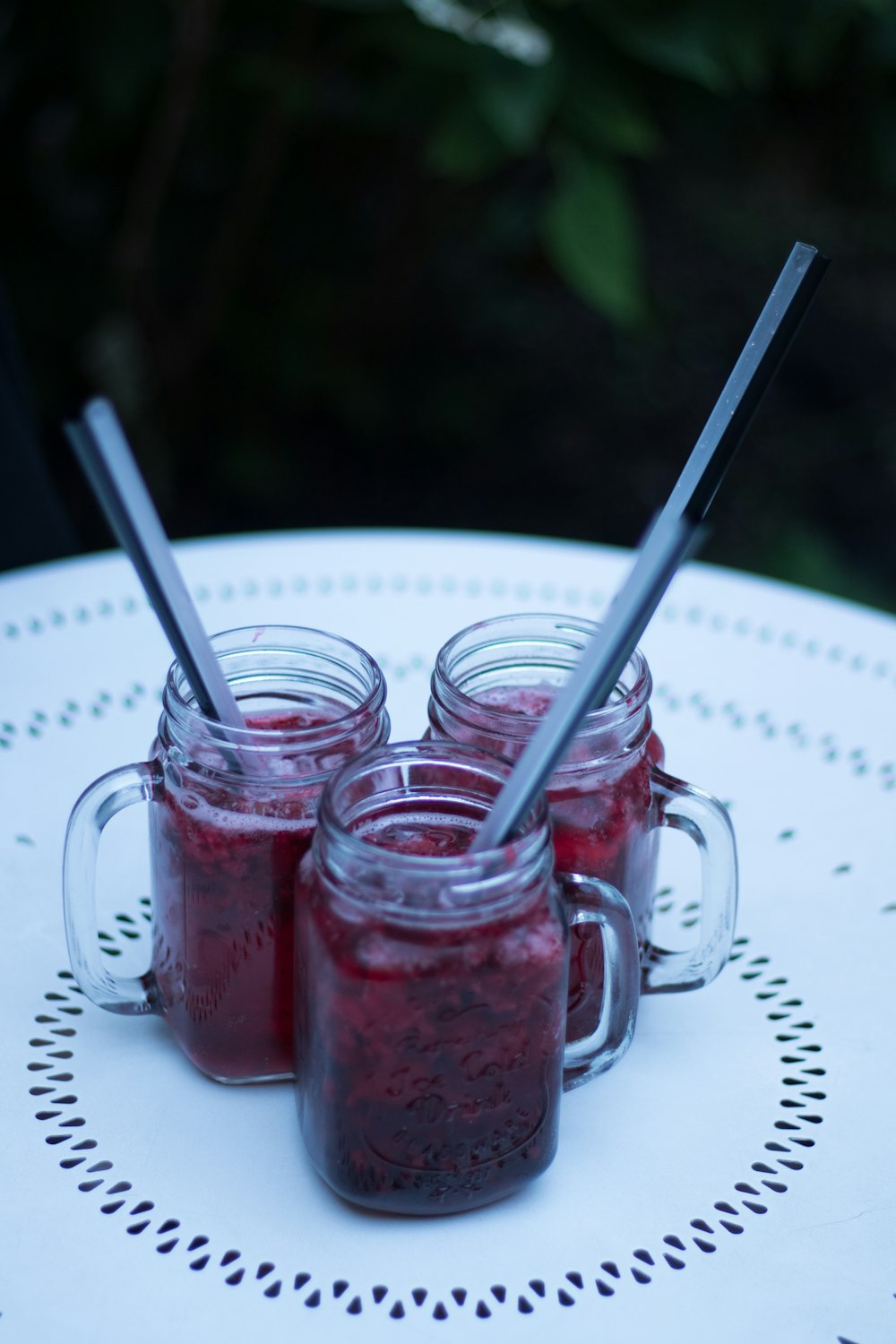 red liquid on clear glass mason jars