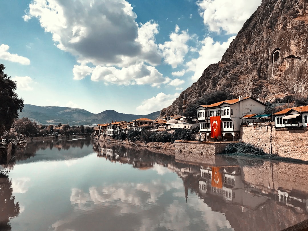 buildings beside calm body of water,