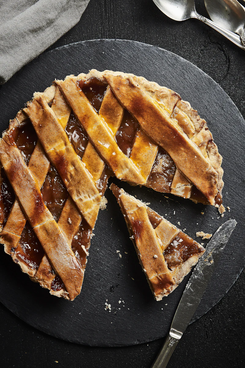 A lattice-crust fruit pie, partially sliced
