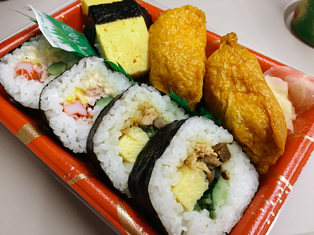 a plate of sushi with a variety of toppings