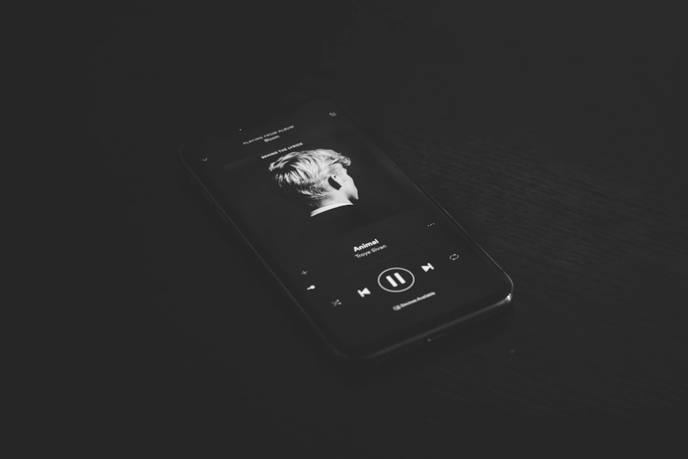 grey smartphone playing music
