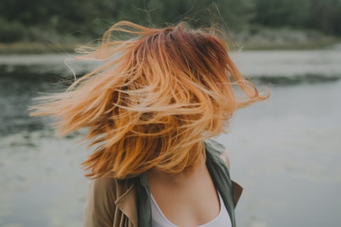 woman looking back near river