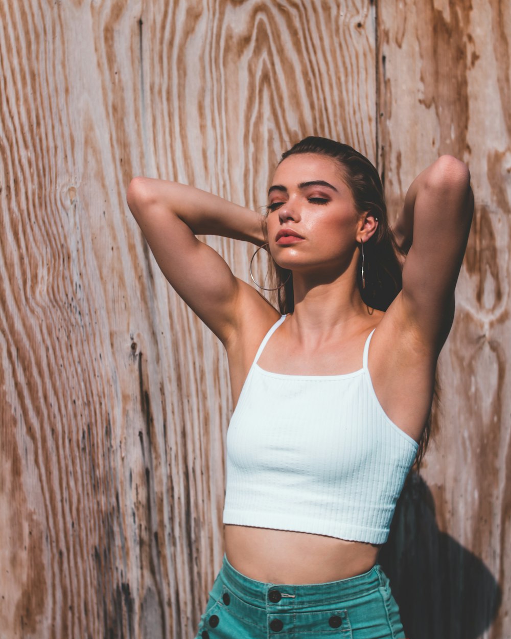 woman wearing white camisole near wall