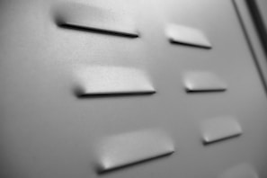 Close-up of a ventilated metal air conditioner cover with a smooth finish