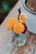 A vibrant bouquet of fresh loose flowers arranged in a simple glass vase.