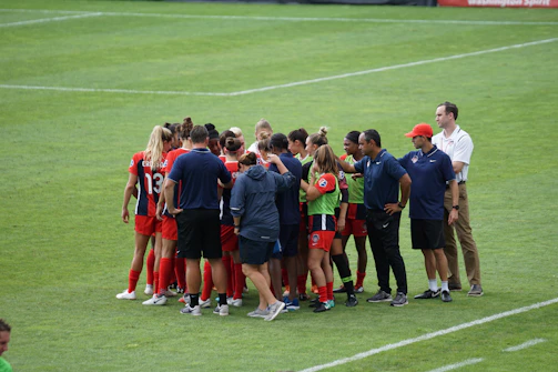 Team huddle of the senior women's football team before a match.