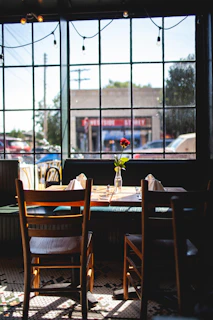 Cozy corner of doceaura with a window view and a small table set for two