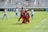 A group of club members celebrating a victory on the field, wearing blue, white, and red jerseys.