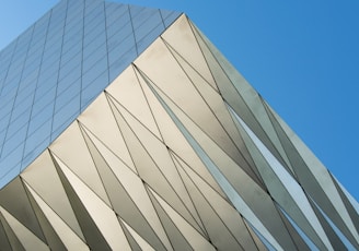 low angle photo of gray building under blue sky