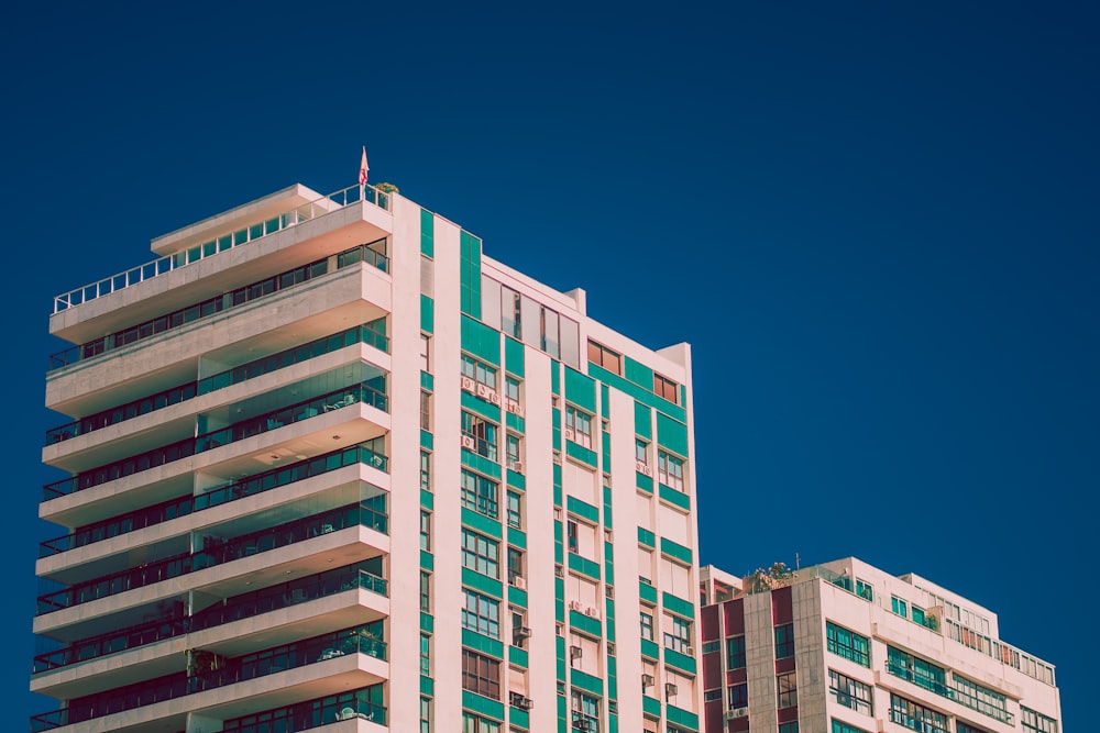 white and green high-rise building