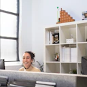 Smiling professional woman sharing her positive experience with SEO services in a cozy office setting.