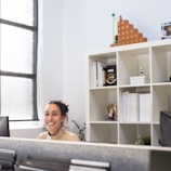 A smiling business owner reviewing sales reports in an office.