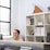 A smiling real estate agent discussing property options with a happy couple in a bright office.