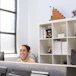 Smiling healthcare professional holding official permit document in a bright office.