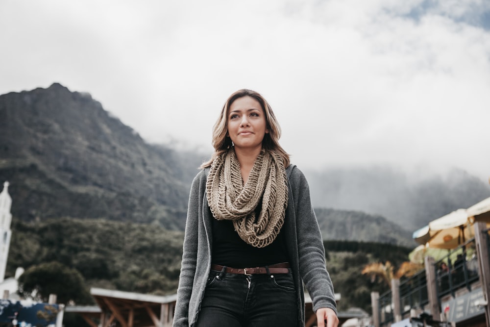 woman wearing gray cardigan and brown scarff