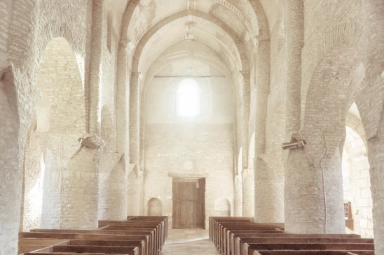 A serene African church interior bathed in natural light, highlighting traditional wooden pews and subtle cultural motifs.