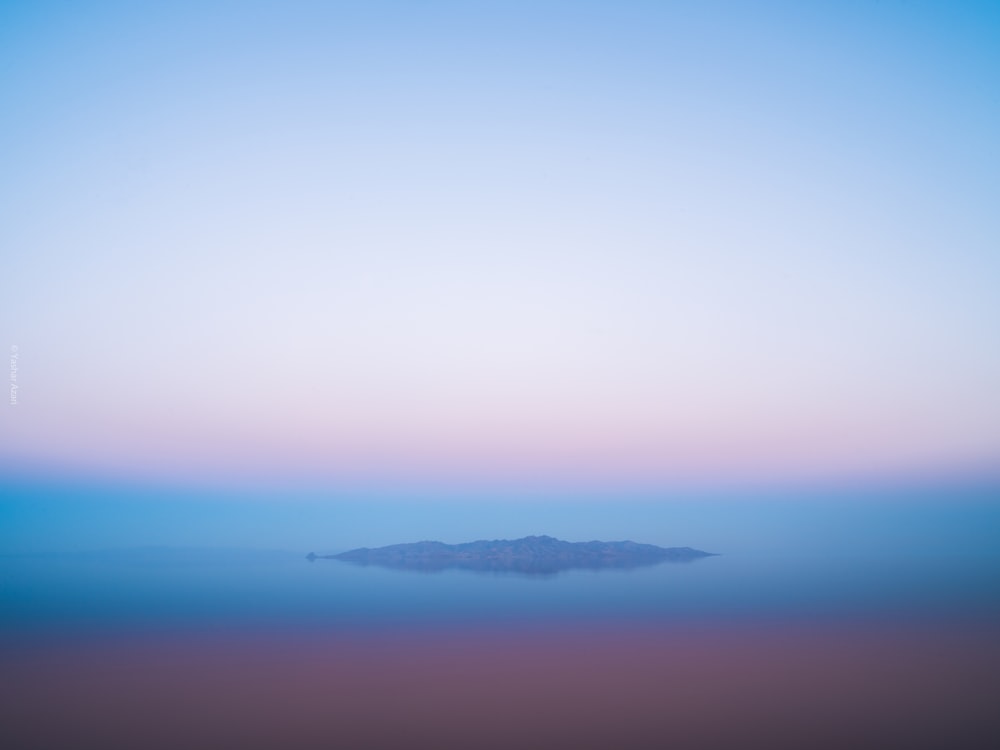 island under clear blue sky