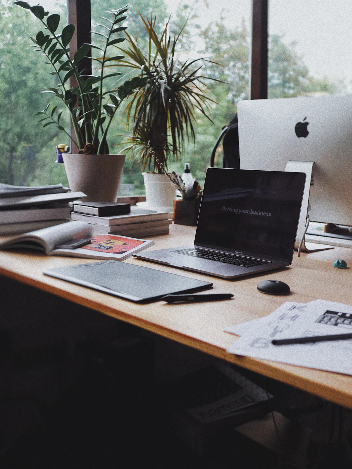 A desk with a legal pad, pen, and coffee under focused light