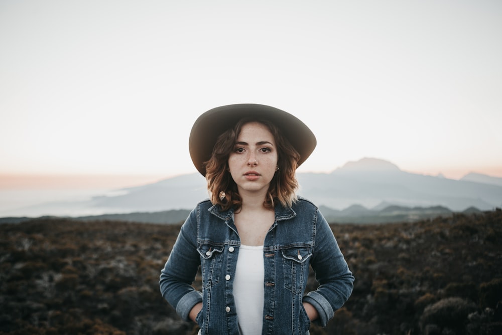 woman holding pouch of jacket standing on road