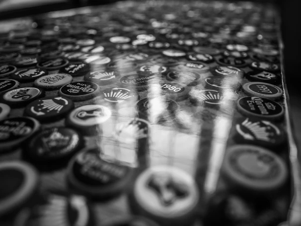 Finished black caps with sharp, premium-quality prints arranged neatly on a wooden table.