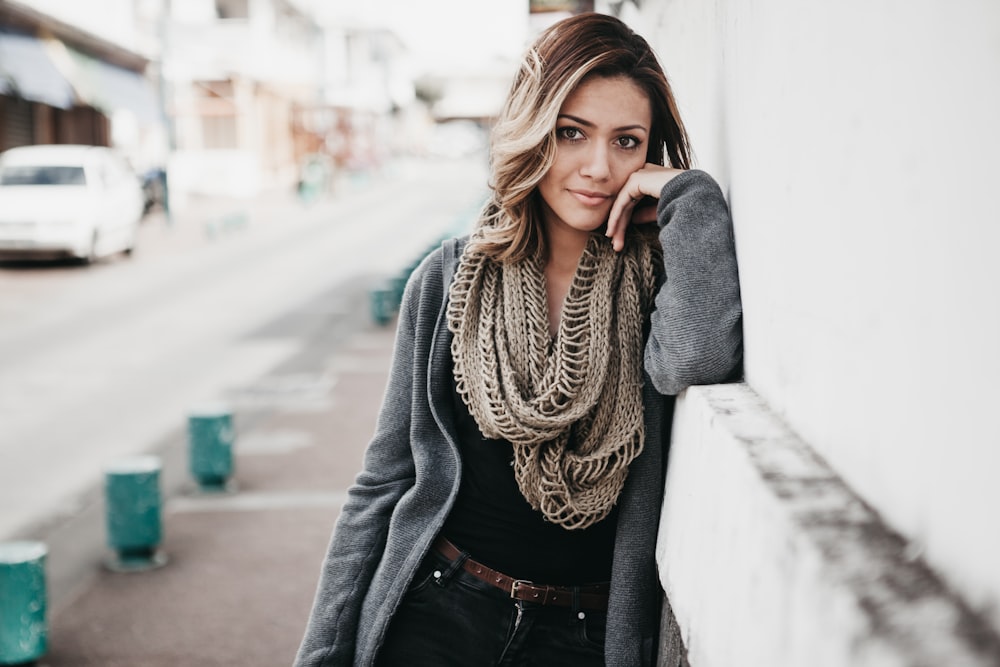 women's brown scarf and gray jacket