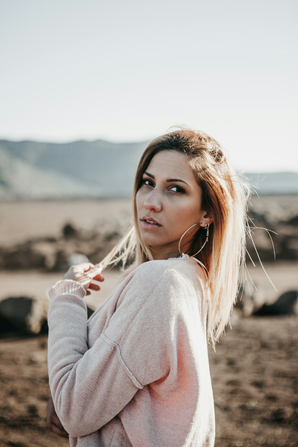 woman standing beside mountain