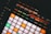 An electronic music production controller featuring illuminated pads and digital display with sound frequency controls. Various buttons and sliders with labels like 'Mute', 'Solo', and 'Quantize' are visible.