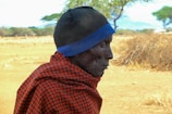 Elderly individuals receiving warm clothing and blankets.