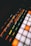A vibrant close-up of a music producer working on a digital audio workstation with orange accents.