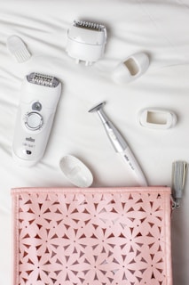 epilator and shaver on white cloth