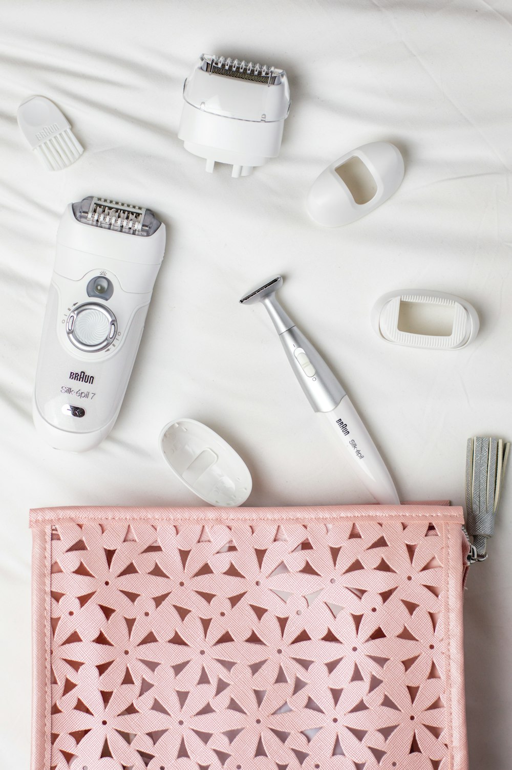 epilator and shaver on white cloth