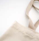 brown tote bag on white surface