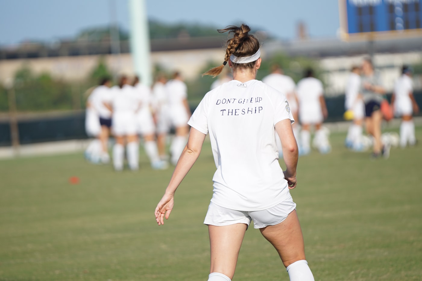 woman standing in front of women at the field during day