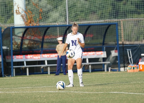 Close-up of a focused player preparing for a free kick, showcasing determination and concentration.