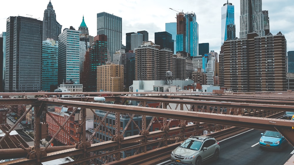 aerial photography of vehicles travelling on bridge near cityscape during daytime