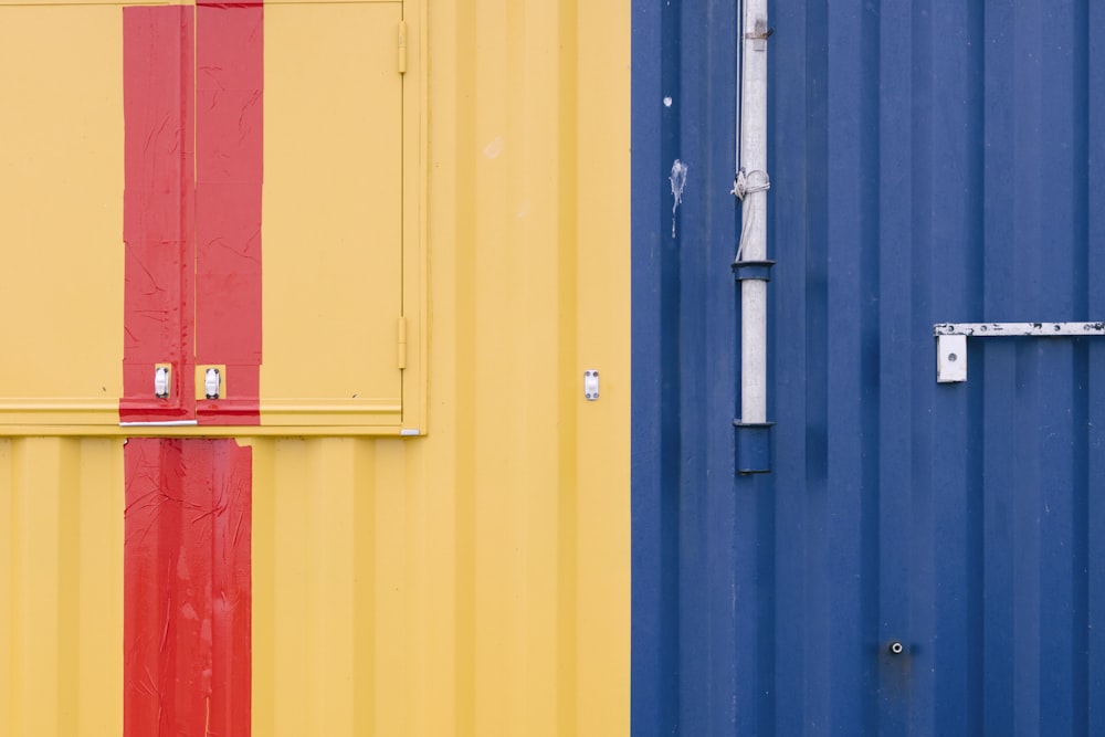 a blue and yellow building with a red stripe